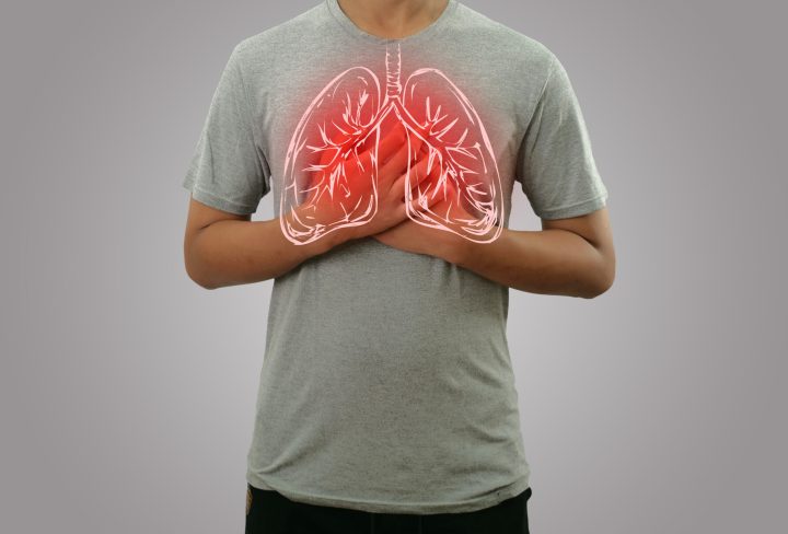 Male person holding chest, feeling pain with lung illustration on the torso, respiratoy system disease concept